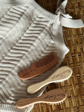 Personalised wooden baby hairbrush, comb and bristle brush set, engraved with name, on knitted blanket
