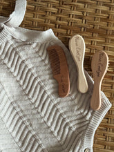 Personalised wooden baby hairbrush, comb and bristle brush set, engraved with name, laid flat on knitted blanket
